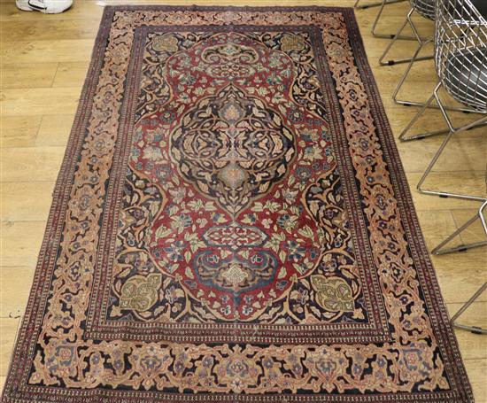 A Persian puce ground rug 218 x 138cm